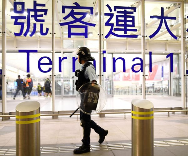 Riot Police Clash With Protesters at Hong Kong Airport