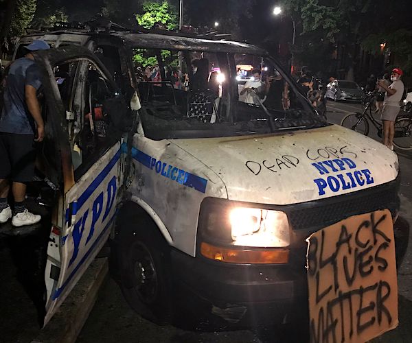 riots destroy a police cruiser and write dead cops on its hood