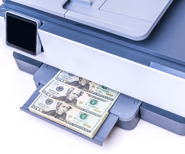a copy machine printing twenty dollar bills