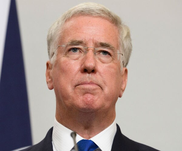 Britain Defense Minister Resigns for Touching Journalist