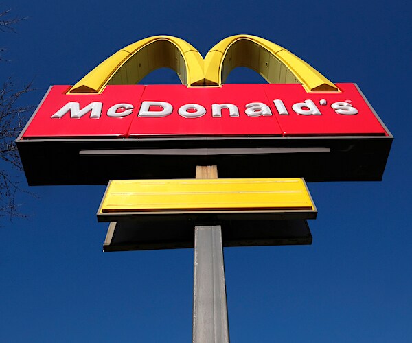 the famed golden arches of mcdonald's against a bright blue sky