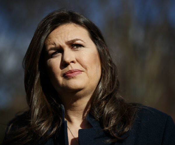 sarah sanders is shown wearing a navy suit