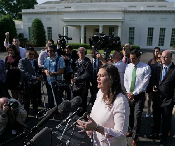 sarah sanders talking to the press outside the white house