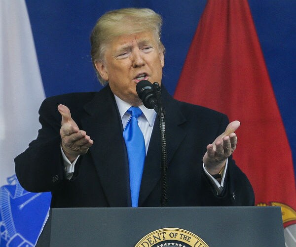 president donald trump gestures with his hands as he speaks
