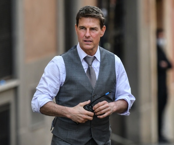 cruise in a light blue shirt and gray vest