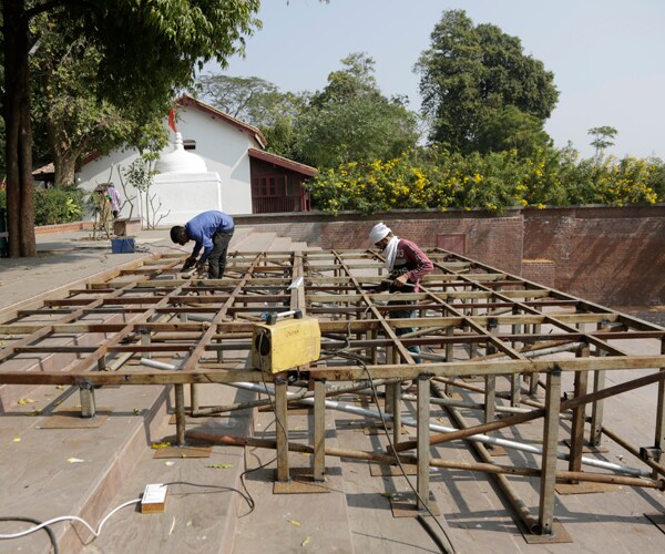 workers build a stage ahead of a visit by president donald trump in ahmedabad, india