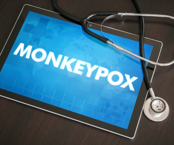 monkeypox on screen of tablet, stethoscope next to it