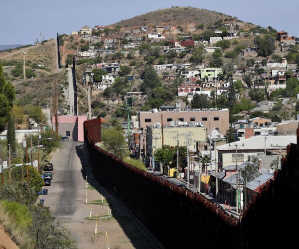 the us-mexico international border cuts through Nogales, Ariz., from Nogales, Ariz., left, and Nogales, Sonora, Mexico.