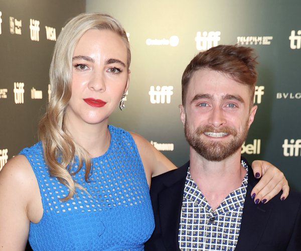 Erin Darke and Daniel Radcliffe posing for a photo