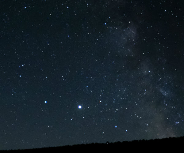  a wind turbine and Milky Way are seen just after midnight
