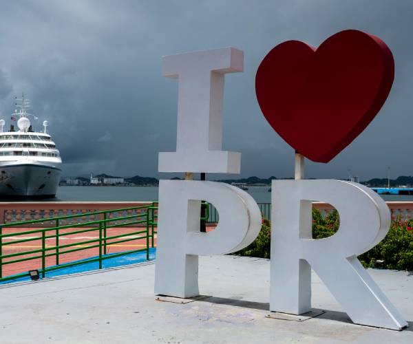a ship at dock in front of a sign reading i heart p r