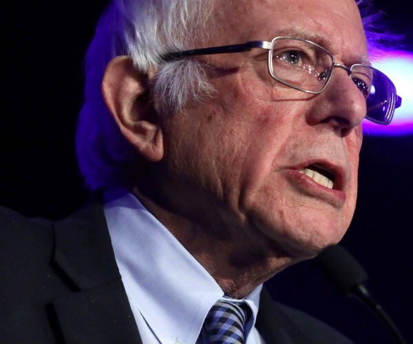 bernie sanders speaks  in las vegas in suit, dress shirt and tie