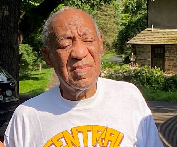 bill cosby stands in the sun