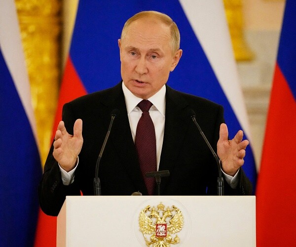 vladimir putin speaks into mic