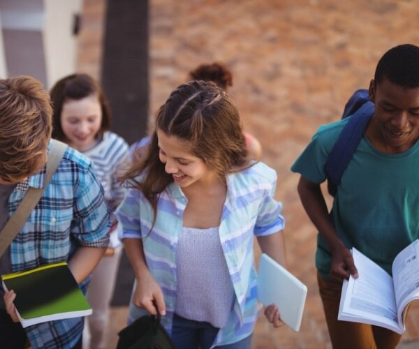 teens running up the stairs at school