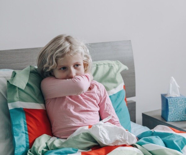 young girl in bed sick/coughing