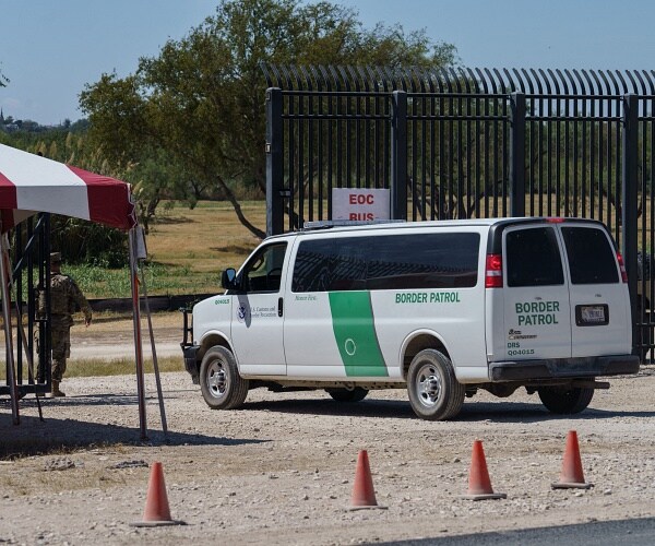border patrol van drives through gate