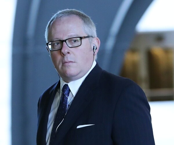 Michael Caputo walking down a hallway