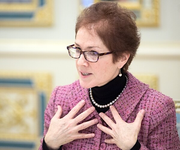 marie yovanovitch holds her hands to her chest while speaking