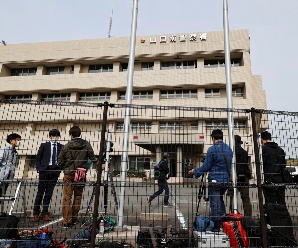 media gather outside a police station