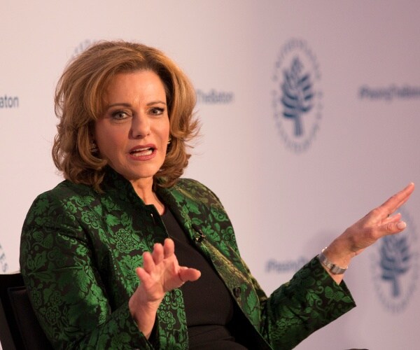 kt mcfarland in a green and black jacket and black top