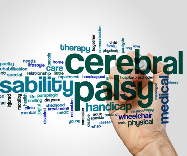 a hand writing the words cerebral palsy on glass