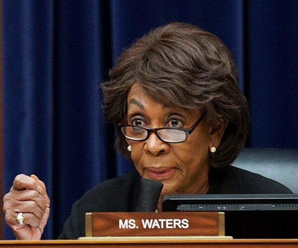 maxine waters speaks into microphone