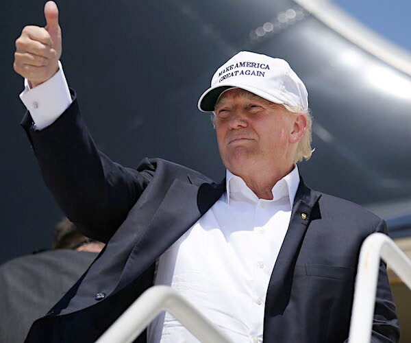 president donald trump gives an emphatic thumbs up as he greets revelers coming off air force one