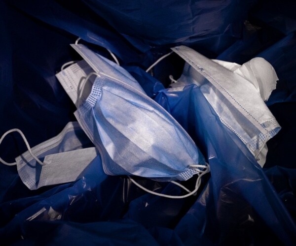 Used protective masks in the trash