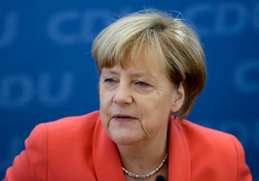 The Latest: Merkel Stands by Migrant Stance Despite Setbacks