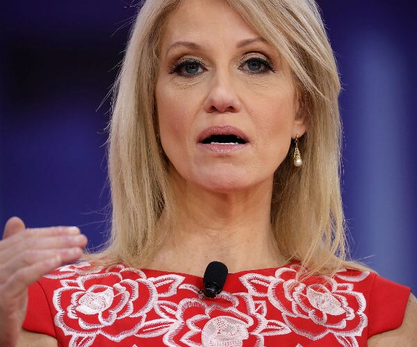 Presidential senior counselor Kellyanne Conway speaks to reporters in a red blouse