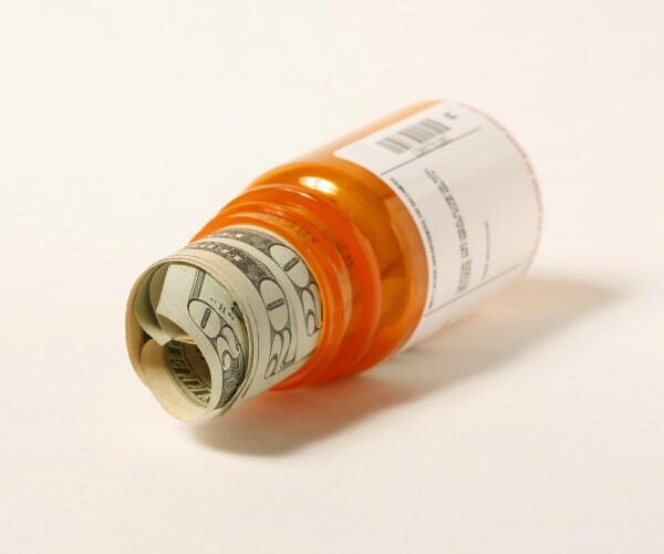 prescription bottle with $20 bills in it