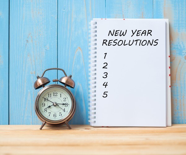 new year resolution empty list on table with clock counting down 
