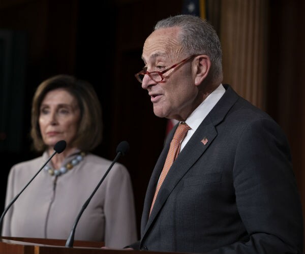 house speaker nancy pelosi and chuck schumer are shown at a press conference.