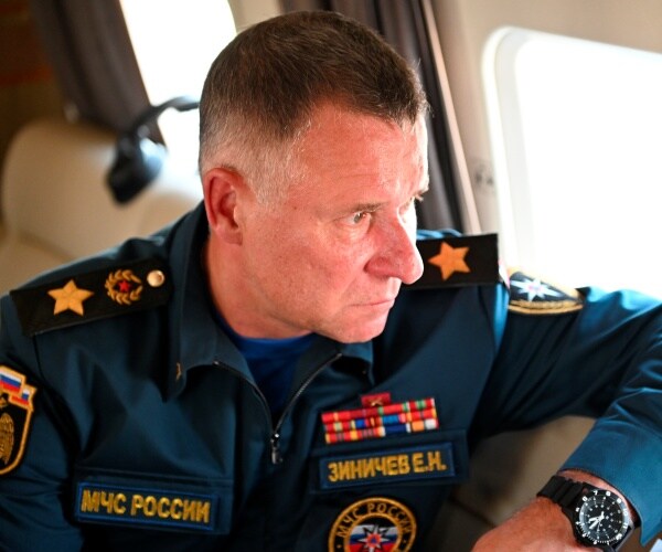 Yevgeny Zinichev  aboard a helicopter.