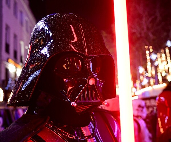 darth vader holds lightsaber