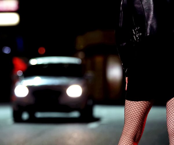 car approaching woman