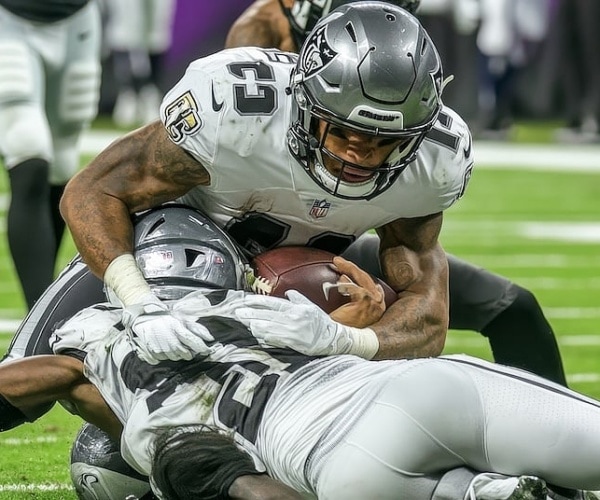 football players in a tackle during game