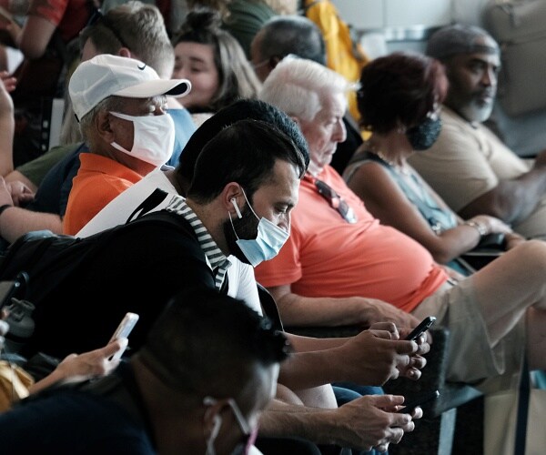 people sit on bench waiting for ferry
