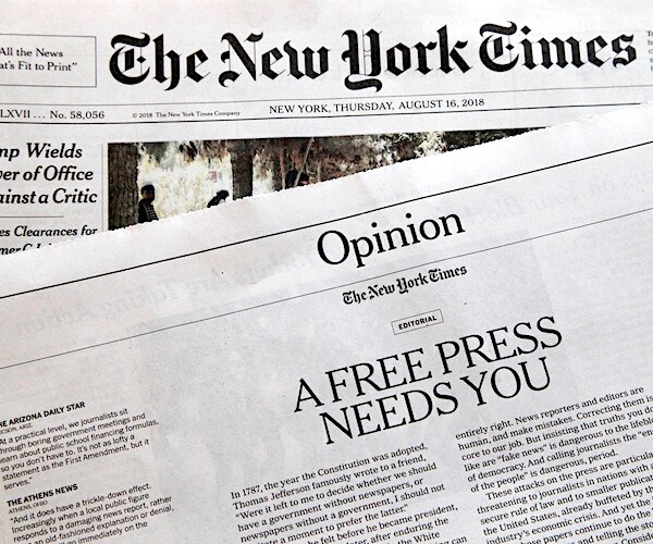 stacks of the new york times newspaper read opinion: a free press needs you