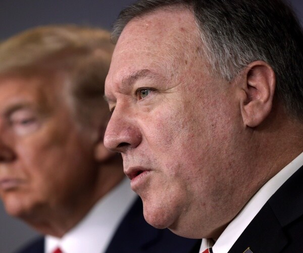 close-up sideview of mike pompeo speaking next to trump