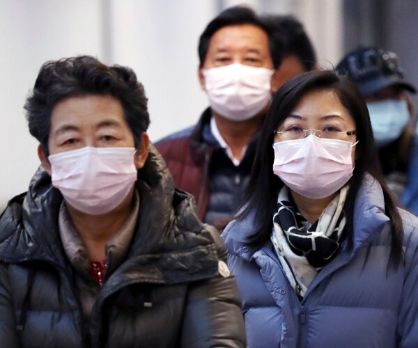passengers wear masks to protect against the coronavirus at narita international airport in tokyo