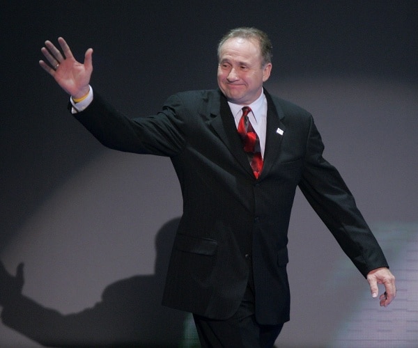michael reagan waves on stage.