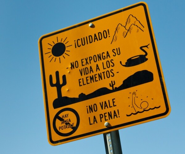 yellow warning sign for illegal immigrants near the us-mexico border