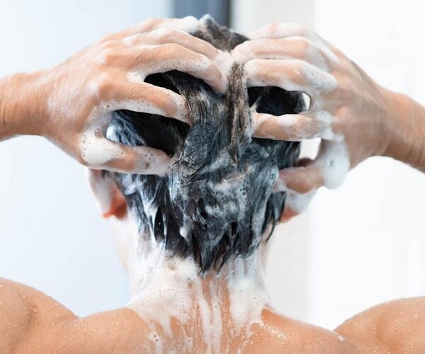 woman washing hair in shower