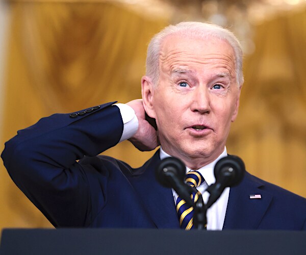 joe biden scratches the back of his neck in bewilderment at a press conference
