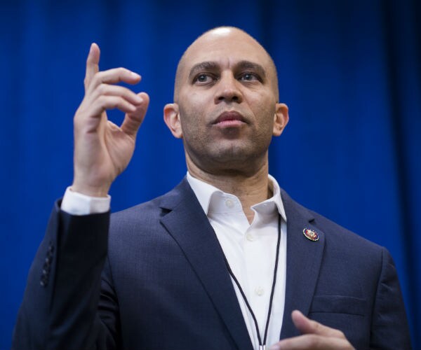 Democratic Caucus Chair Hakeem Jeffries points up as he speaks to the media