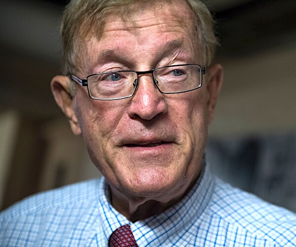 paul cook stands and listens to reporter's questions during a news conference