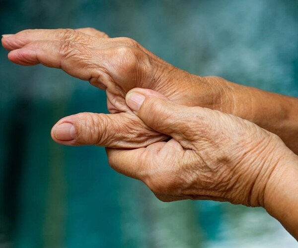 person holding hand because in pain