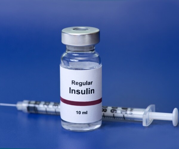 vial of insulin and a syringe